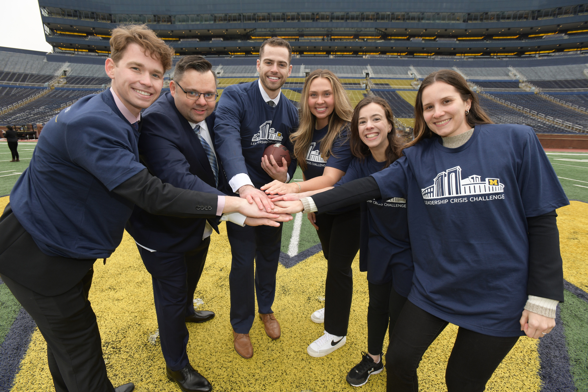 Students smiling on the field in the Big House