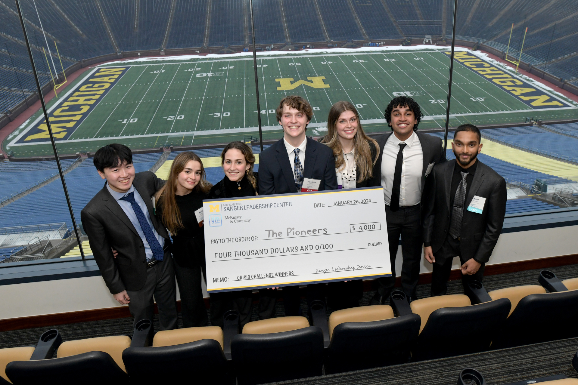 The Pioneers posing with their check