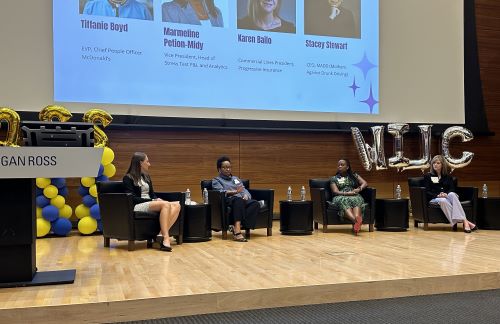 Four women speakers sitting on stage at the Women in Leadership Conference