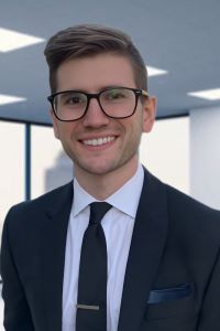 Photo of Trent Fields Michigan Ross Online MBA student wearing a black suit white shirt and black tie and glasses