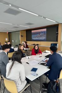 Group of Michigan Ross students sitting around a table in New York City. 