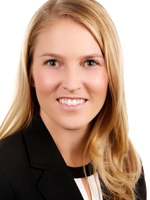 Allison smiles in front of a white background