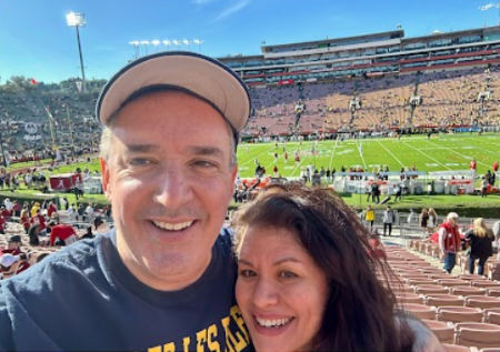 A couple smiling at a football game