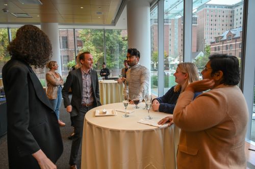 Students gathered around a table at the event, having a discussion