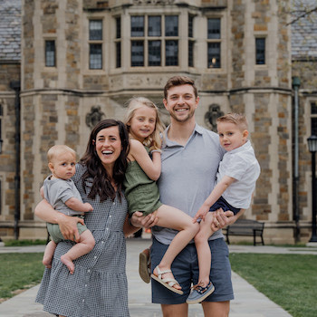 Family of 5 poses for photo.