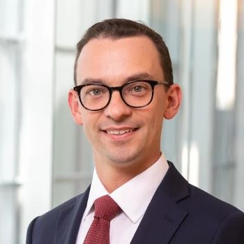 Man in suit with glasses smiling for portrait photo