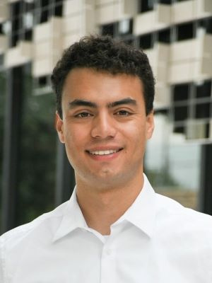 Man in a white shirt with buildings in the backrgound