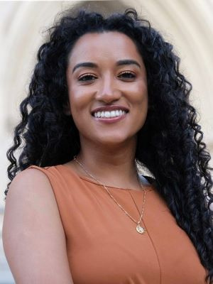 Juli Adhikari smiles in a headshot photo