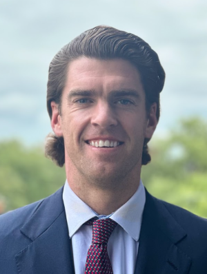 Zach Perkins smiles in a headshot photo