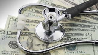 Photo illustration of stethoscope with hundred dollar bills