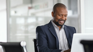 man seating working in a laptop