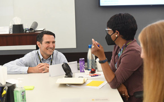 Woman talking to faculty member during Executive Education program