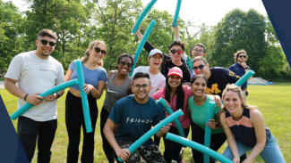 The MBAn cohort smiles with pool noodles in hand