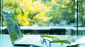 Laptop in front of greenery