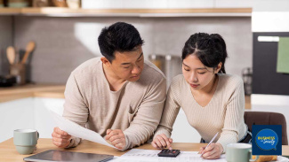 A couple sitting at the counter going over taxes