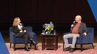 Dean Sharon F. Matusik and Nick Hornby chatting during the Handleman Lecture