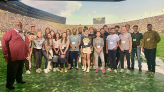 Group photo of Michigan Ross Online MBA students gathered in the digital studio on campus. 