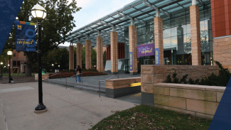 The Ross School of Business building exterior, shot in the early evening with the streetlights on