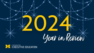 Blue back ground with lighter blue stars, with text displaying 2024 Year in Review, Michigan Ross Executive Education