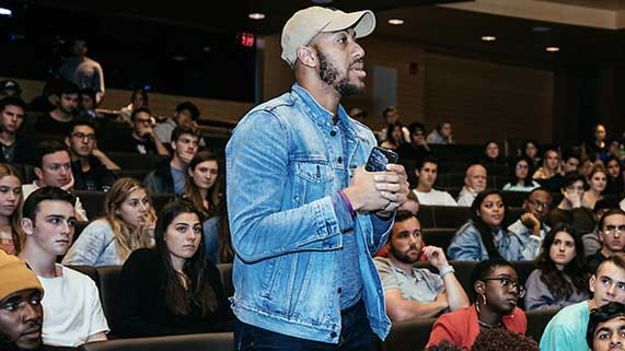 Student asking question at a speaker event