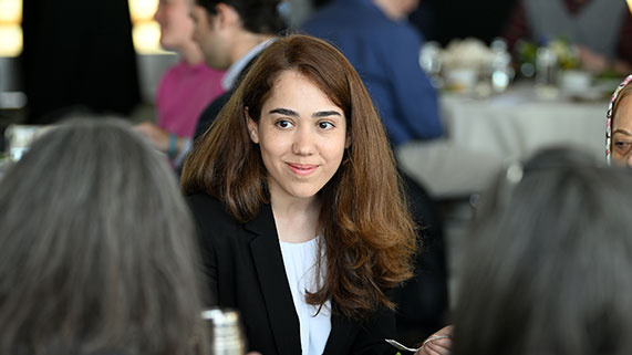 PhD student talking at a table