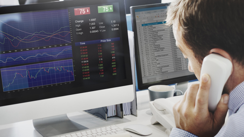 Photo illustration of business person on phone, looking at computer screen