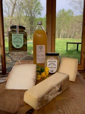 Various cheeses and snacks on a cheeseboard